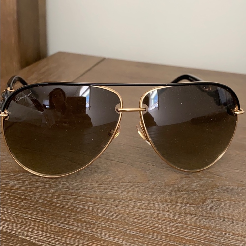 Women’s black and gold aviator sunglasses